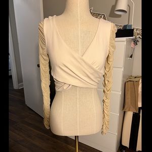 Cream bebe long sleeved crop top.